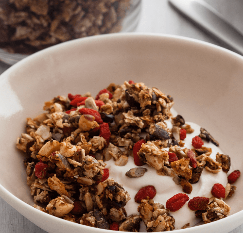 Bowl of seeded granola with yogurt and goji berries