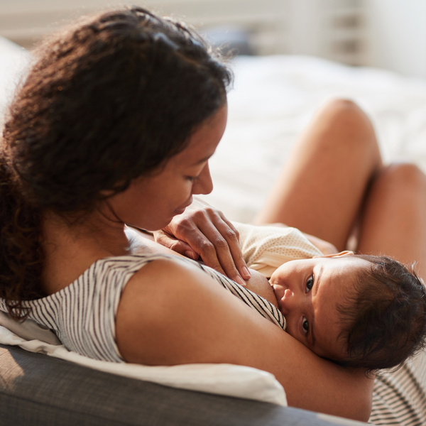 Mother breastfeeding her baby while lying down