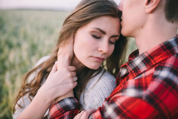 Couple embracing closely in a wheat field