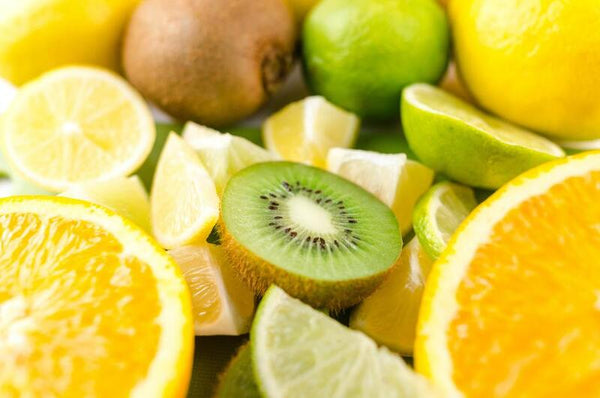 Close-up of sliced lemons, limes, oranges and a kiwi arranged together