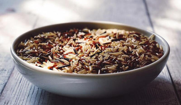 Bowl of mixed wild and brown rice on a wooden table