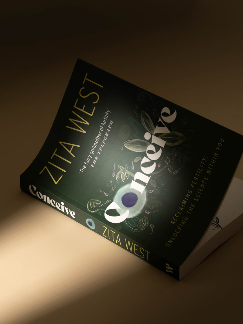 Book titled 'Conceive' by Zita West on a dark background
