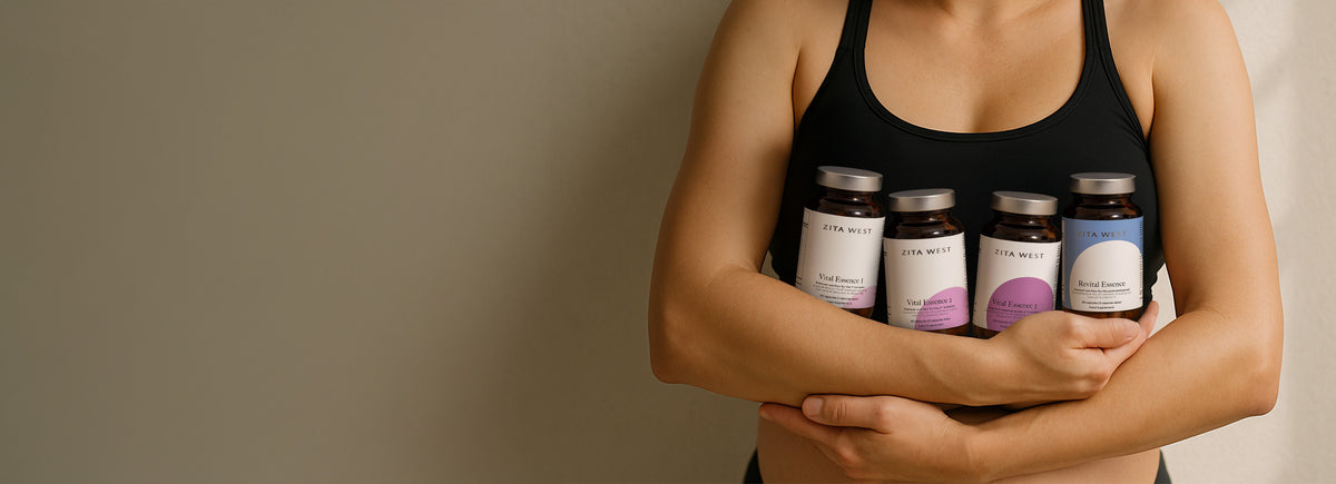 A woman in a black tank top holding the Zita West Vital Essence Range