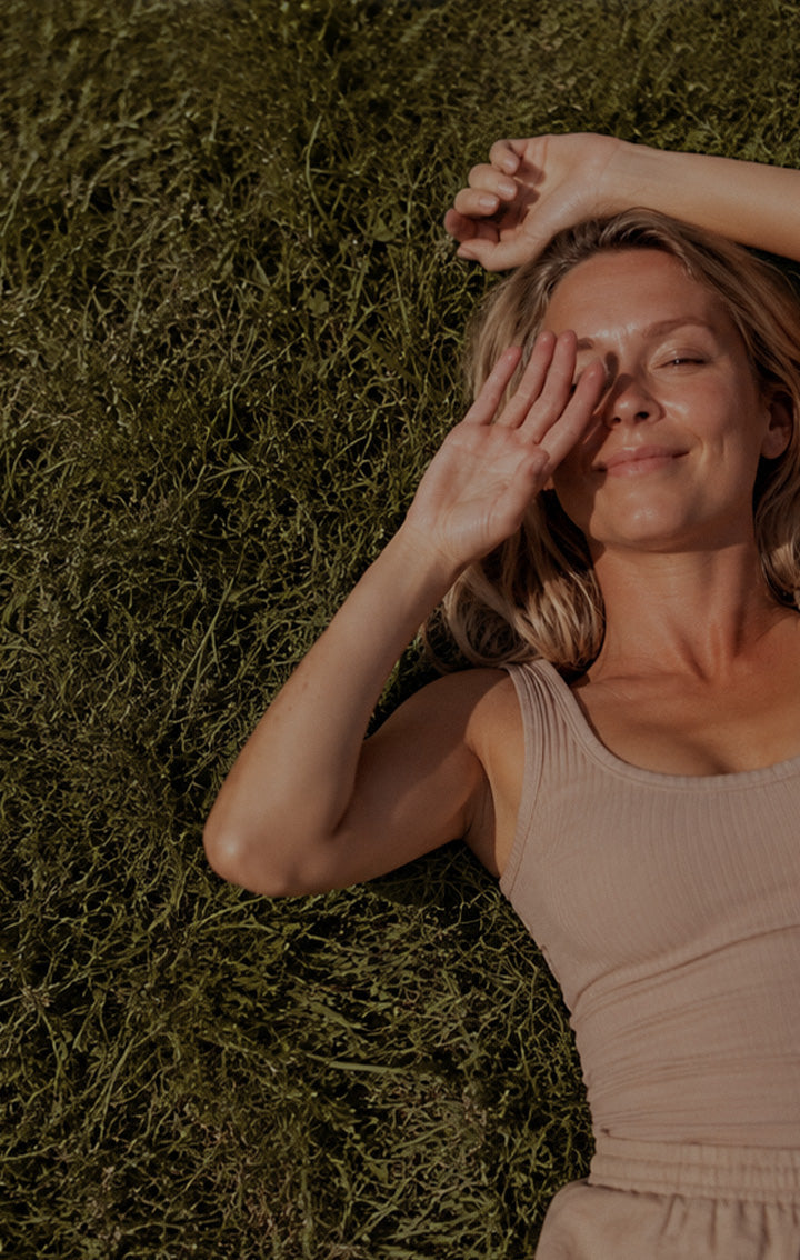 a woman laying on the grass
