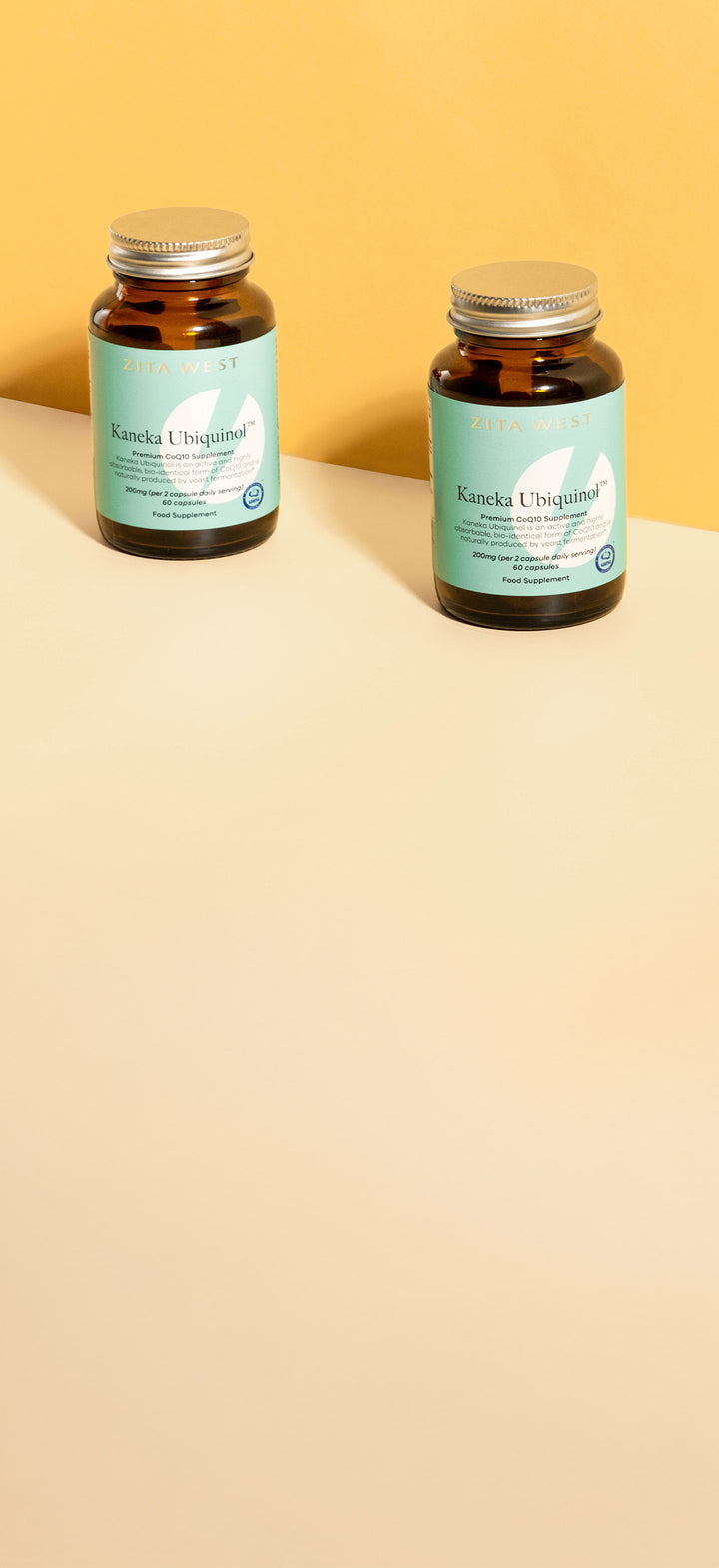 Two bottles of Zita West Kaneka Ubiquinol CoQ10 on a yellow background