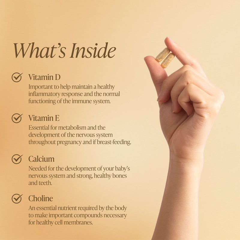 A hand holding two capsules of Revital Essence