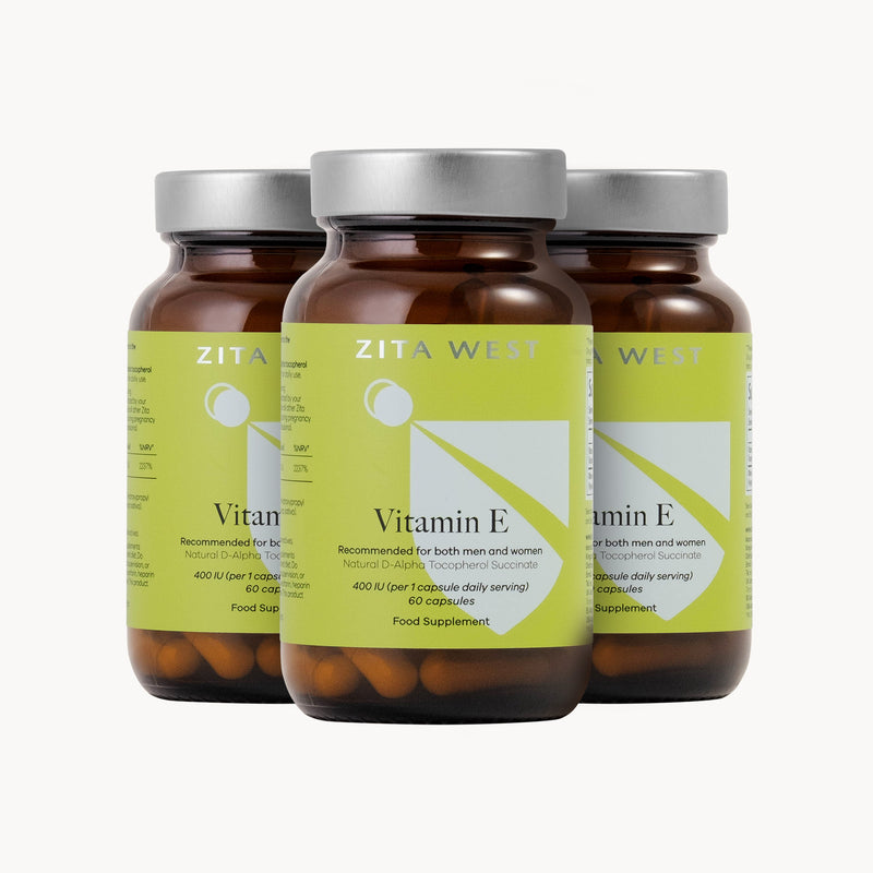 Three bottles of Zita West Vitamin E supplements on a white background