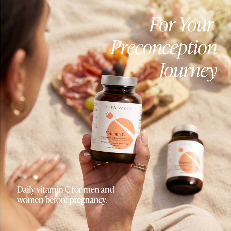 Person holding a bottle of Zita Wellness Vitamin C supplement with text about preconception journey.