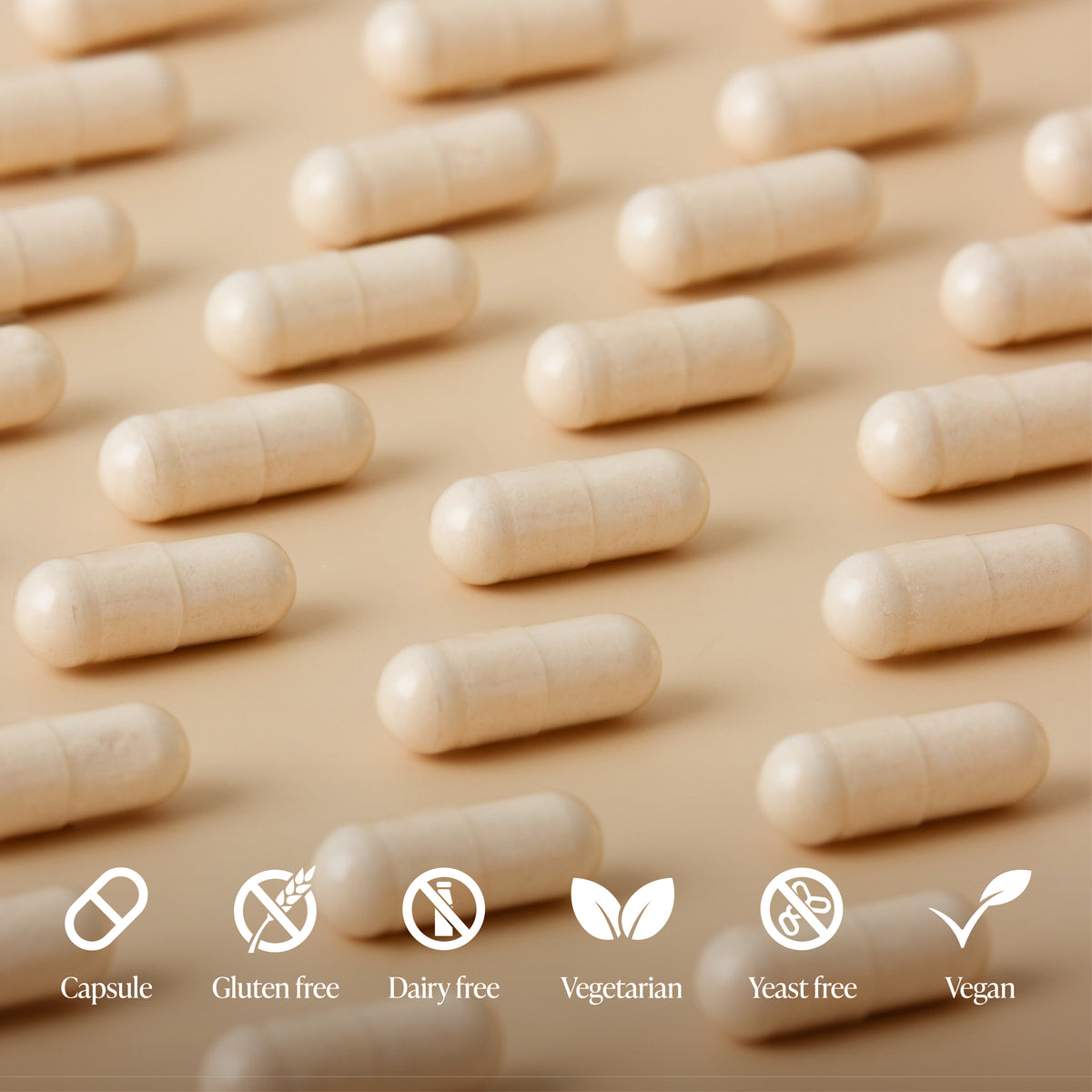 Row of beige capsules on a beige background with dietary freedom icons below.