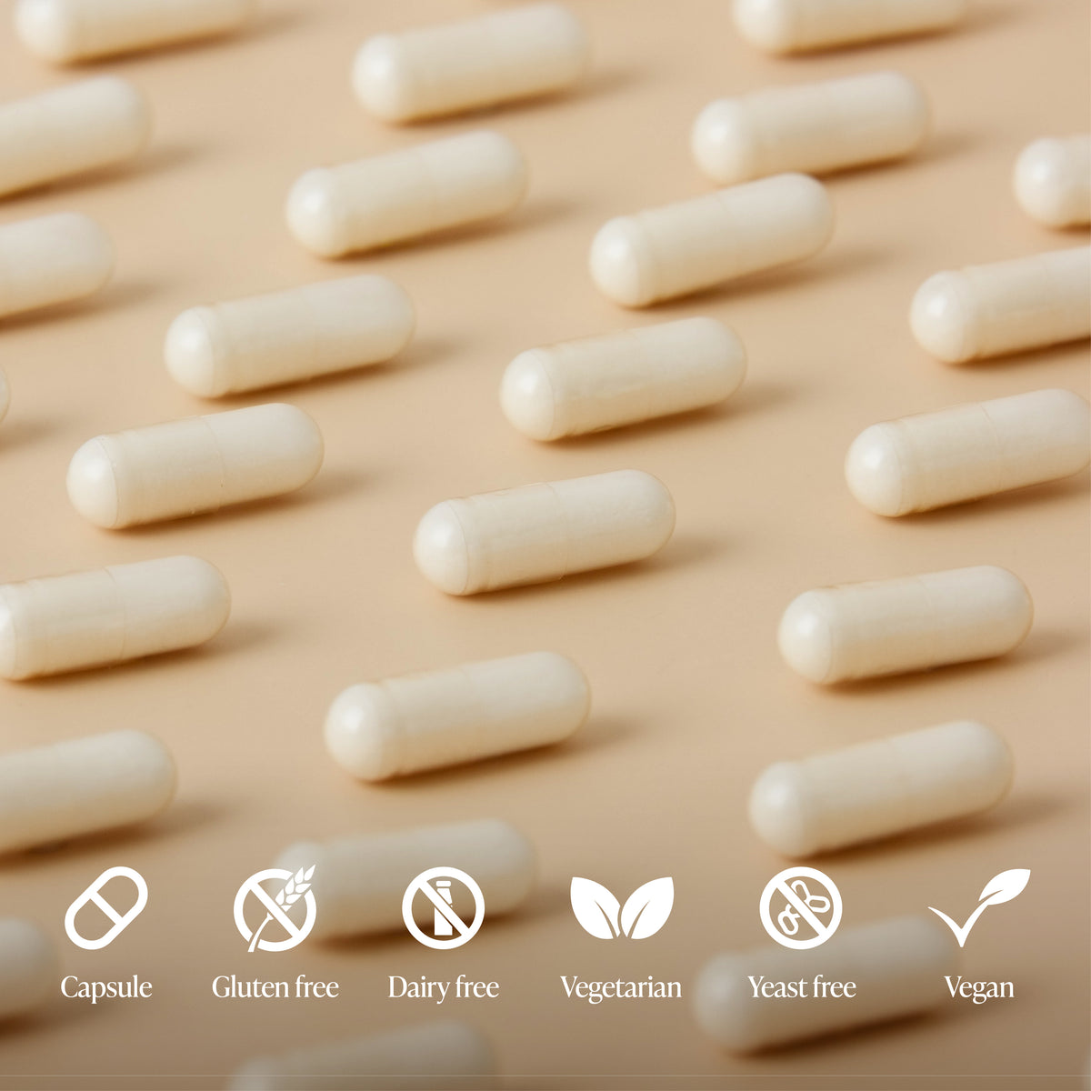 White capsules arranged in rows on a beige background with dietary label icons.
