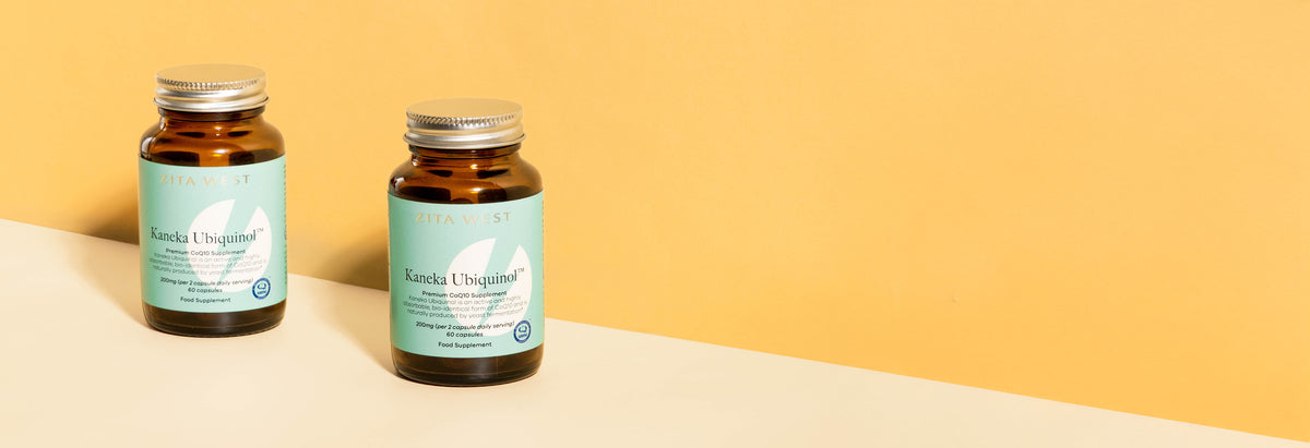 Two bottles of Zita West Kaneka Ubiquinol CoQ10 on a yellow background